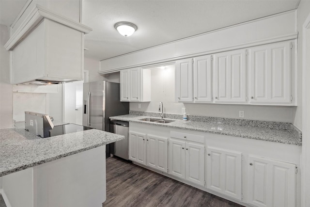 kitchen featuring light stone counters, appliances with stainless steel finishes, dark wood-style flooring, white cabinetry, and a sink