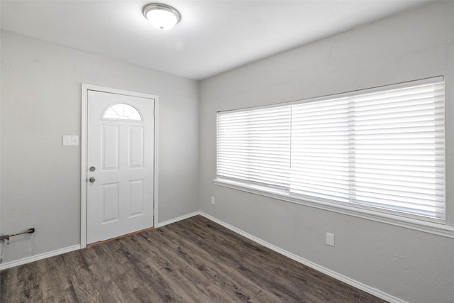 entryway featuring baseboards and dark wood-style flooring