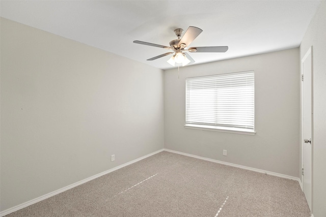 empty room featuring carpet floors, baseboards, and a ceiling fan