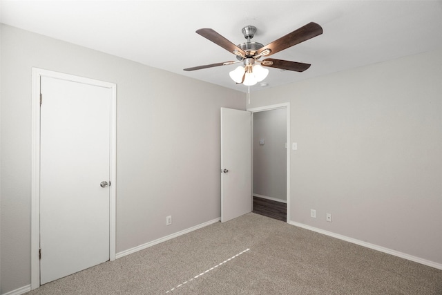 unfurnished bedroom featuring a ceiling fan, carpet, and baseboards