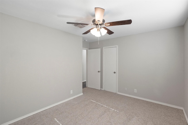 unfurnished bedroom with ceiling fan, baseboards, and light colored carpet