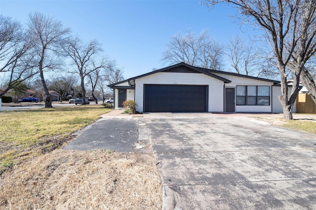 view of home's exterior featuring an attached garage, a lawn, and concrete driveway