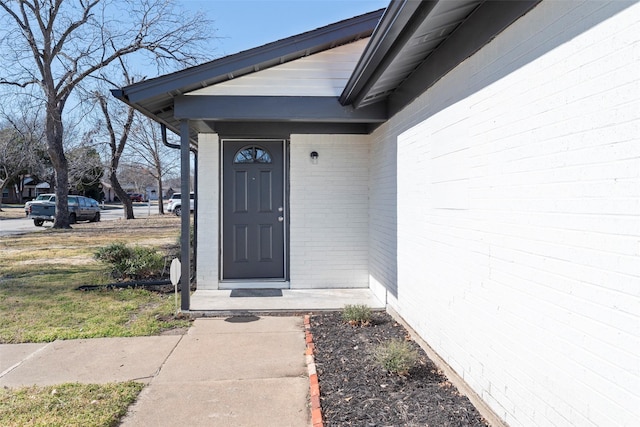 property entrance with brick siding