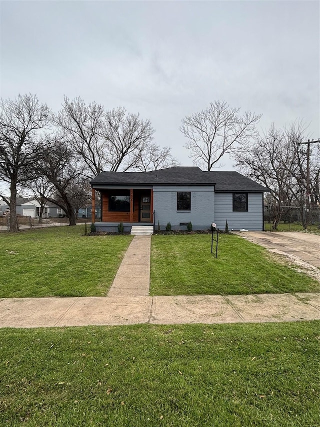 view of front of property with fence and a front lawn