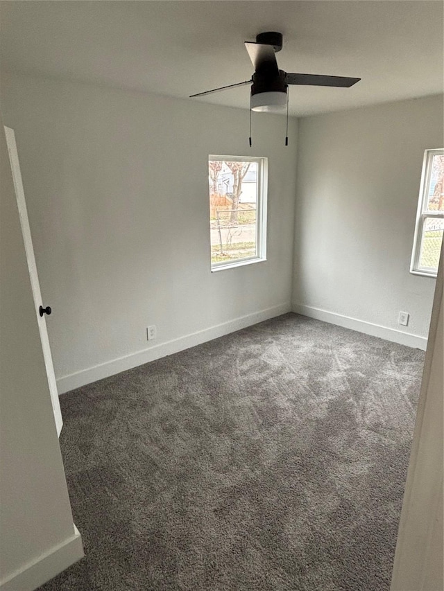 spare room featuring carpet floors, a ceiling fan, and baseboards