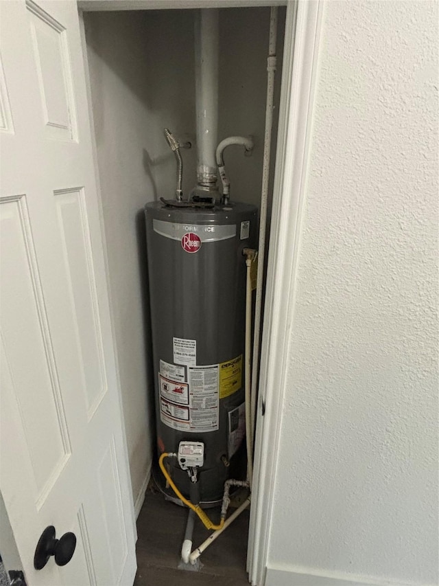 utility room featuring water heater