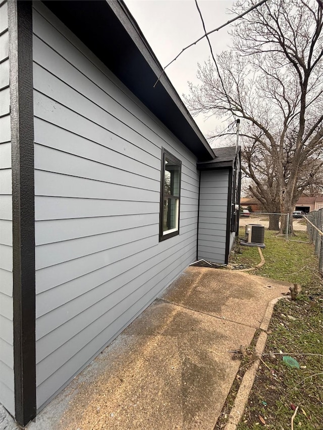 view of home's exterior featuring a patio area, cooling unit, and fence