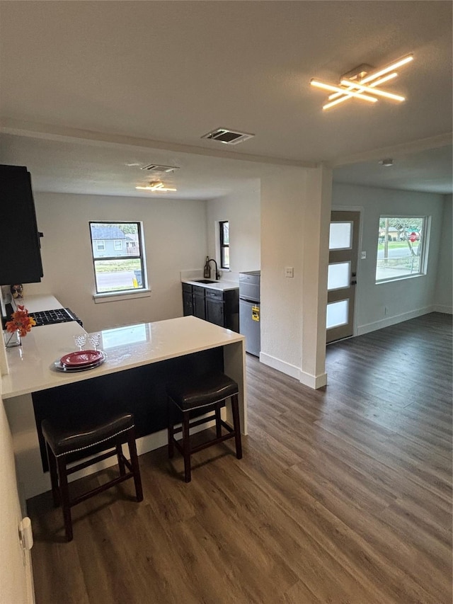 dining area with visible vents, dark wood finished floors, and baseboards