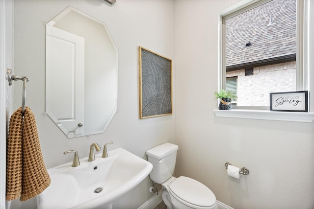 half bath featuring a sink and toilet