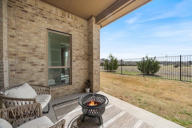 view of patio / terrace featuring an outdoor fire pit and fence