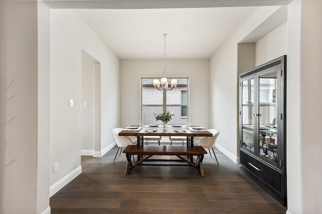 dining room with baseboards, dark wood finished floors, and a healthy amount of sunlight