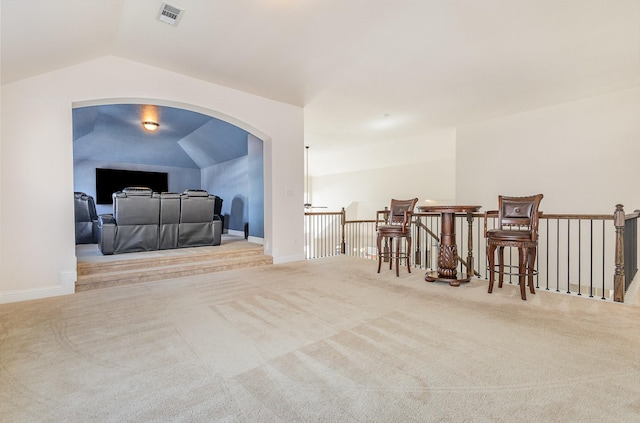 interior space featuring carpet floors, visible vents, vaulted ceiling, and baseboards