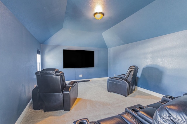 cinema room featuring lofted ceiling, carpet flooring, and baseboards