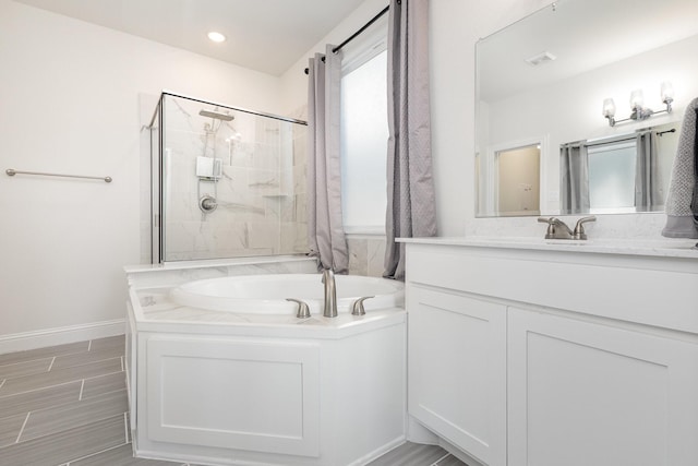 full bath with visible vents, baseboards, a garden tub, vanity, and a shower stall