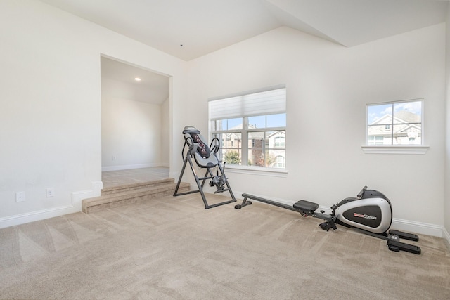 exercise area with carpet, baseboards, and vaulted ceiling