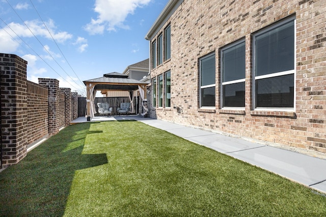 view of yard with a patio area, a fenced backyard, and a gazebo