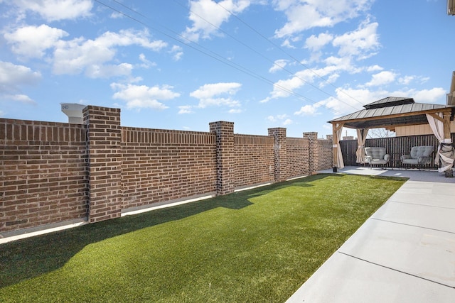 view of yard with a patio area, a fenced backyard, and a gazebo