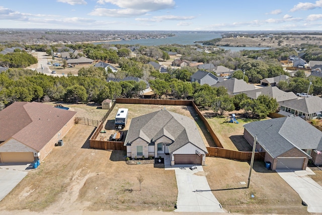 bird's eye view featuring a water view and a residential view