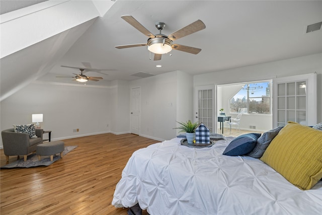 bedroom featuring light wood-type flooring, visible vents, and baseboards