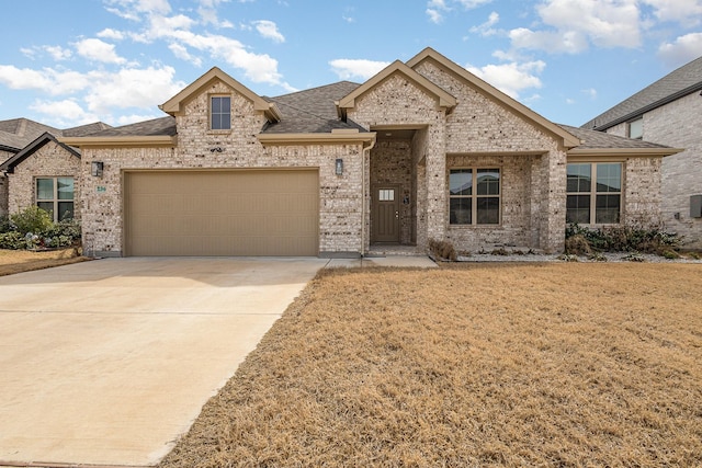 view of front of home featuring concrete driveway, roof with shingles, an attached garage, a front lawn, and brick siding