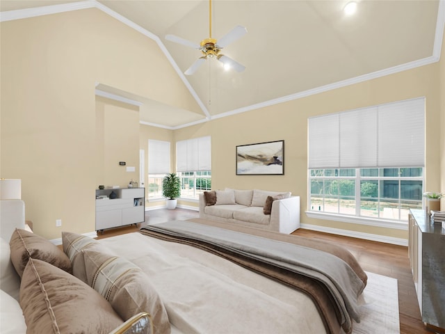 bedroom with baseboards, dark wood finished floors, a ceiling fan, crown molding, and high vaulted ceiling