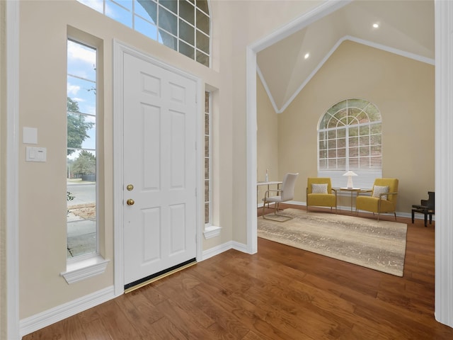 entrance foyer featuring high vaulted ceiling, recessed lighting, wood finished floors, and baseboards