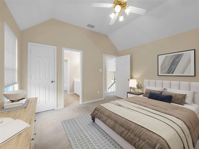 bedroom featuring light colored carpet, visible vents, connected bathroom, vaulted ceiling, and baseboards