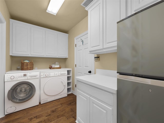 laundry area featuring cabinet space, visible vents, dark wood-type flooring, and independent washer and dryer