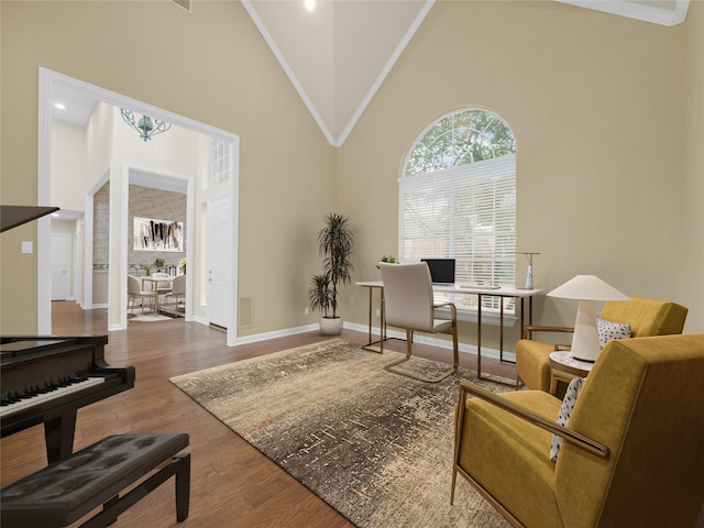 home office with high vaulted ceiling, visible vents, baseboards, and wood finished floors