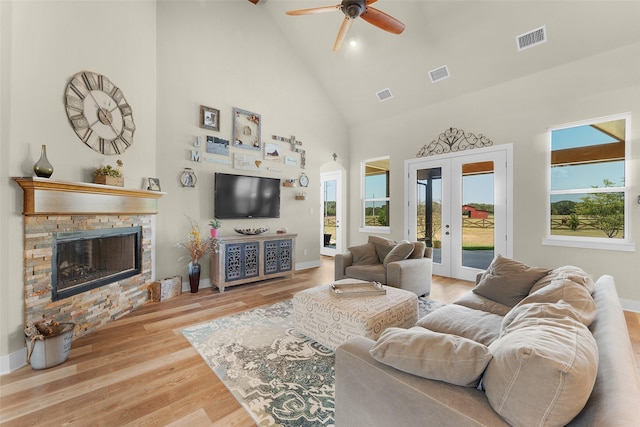 living room with french doors, visible vents, and wood finished floors