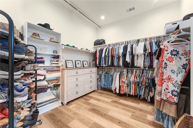 spacious closet featuring wood finished floors and visible vents