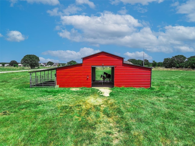 view of pole building with a lawn and a rural view