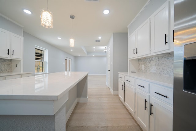 kitchen with light wood finished floors, recessed lighting, white cabinets, and stainless steel fridge with ice dispenser