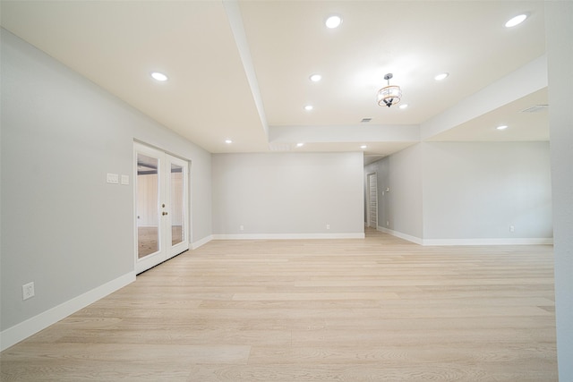 unfurnished room with light wood-type flooring and baseboards