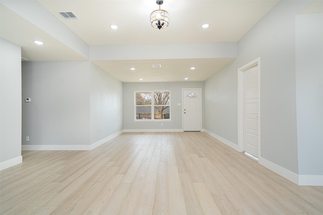 empty room featuring visible vents, recessed lighting, light wood-style flooring, and baseboards