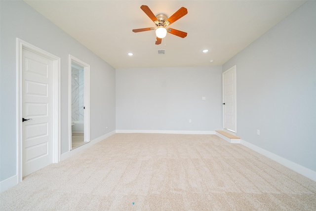 unfurnished room with recessed lighting, baseboards, visible vents, and light colored carpet