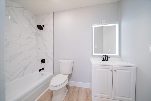 full bathroom featuring shower / tub combination, toilet, wood finished floors, vanity, and baseboards