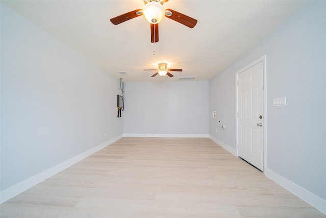 unfurnished room with light wood-type flooring, visible vents, and baseboards