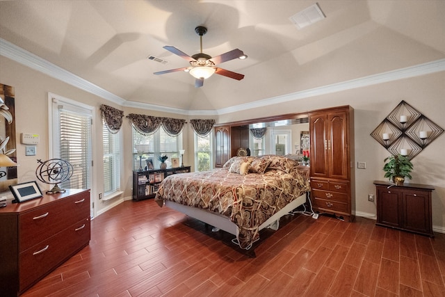 bedroom with ornamental molding, wood finish floors, and visible vents