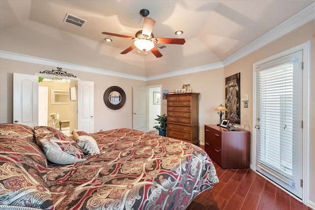 bedroom featuring wood finish floors, a ceiling fan, visible vents, a raised ceiling, and crown molding