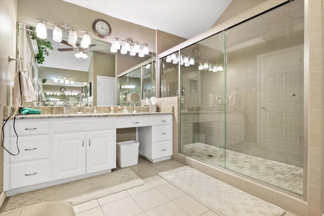 full bath with lofted ceiling, tile patterned flooring, a shower stall, and vanity