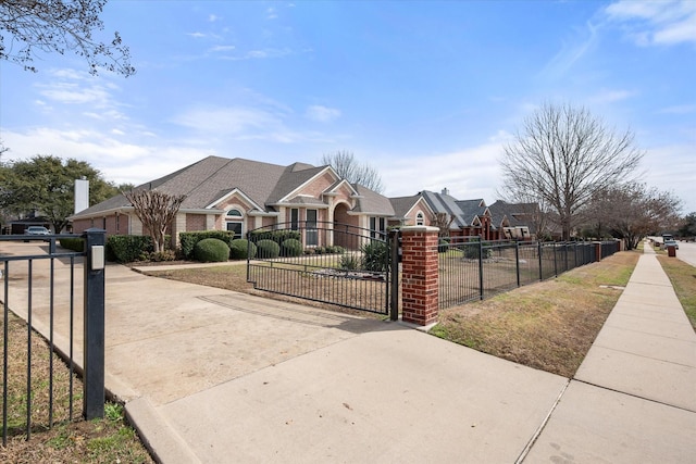 view of front of home featuring a fenced front yard, a residential view, and a gate