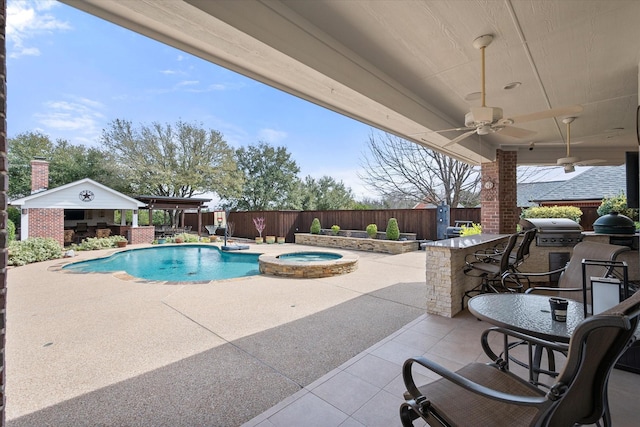 view of pool with a patio, a fenced backyard, an outdoor kitchen, and a grill