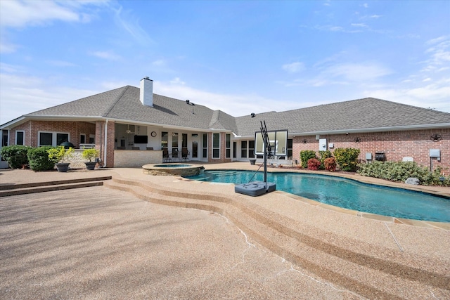 view of swimming pool with a pool with connected hot tub and a patio