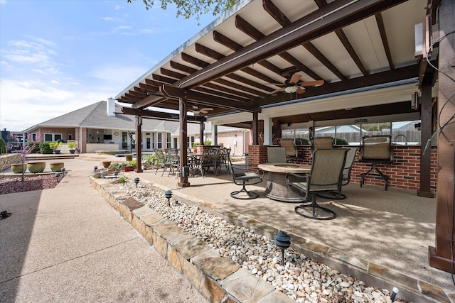 view of patio / terrace with a fire pit and ceiling fan