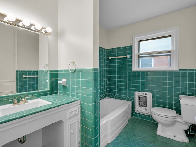 bathroom with heating unit, toilet, a wainscoted wall, tile walls, and tile patterned floors