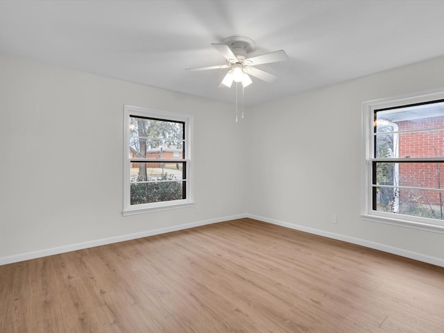 unfurnished room featuring light wood-style floors, ceiling fan, and baseboards