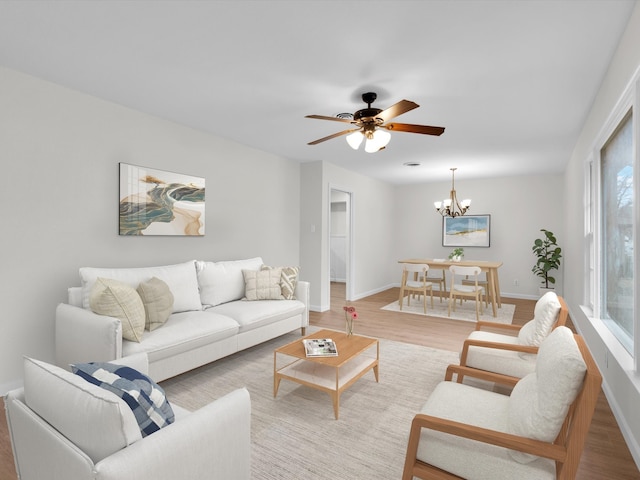 living area featuring light wood-style flooring and baseboards