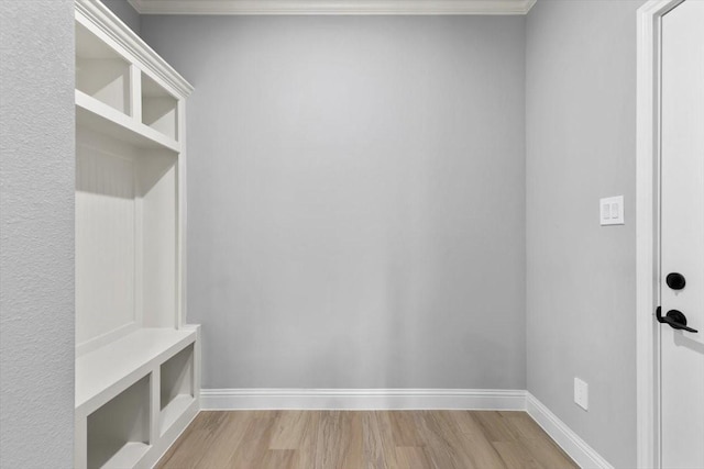 mudroom with light wood finished floors and baseboards