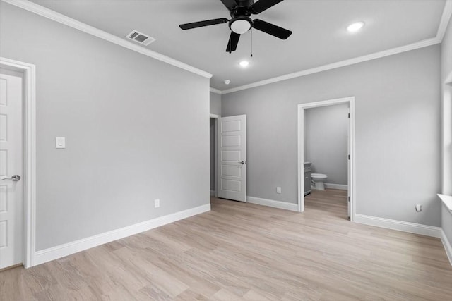 unfurnished bedroom with visible vents, baseboards, light wood-type flooring, ensuite bath, and crown molding